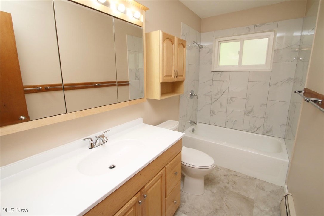 7958 Bellflower Road Mentor, OH 44060 - Photo 23 of 34 Bathroom featuring vanity, bathtub / shower combination, and a baseboard radiator