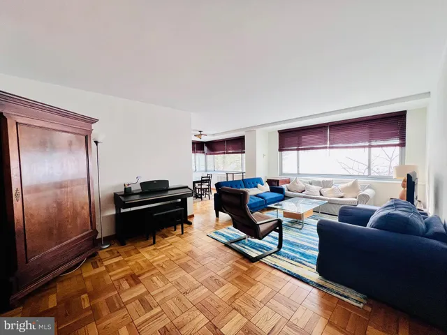 a living room with furniture a rug and a window