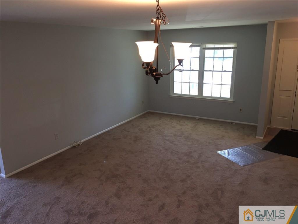 22 Woodbury Road Edison, NJ 08820 - Photo 11 of 25 a view of an empty room with window and chandelier fan