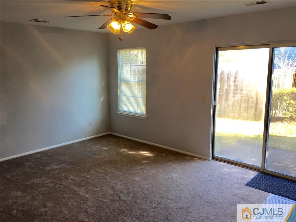 22 Woodbury Road Edison, NJ 08820 - Photo 15 of 25 an empty room with windows and entrance