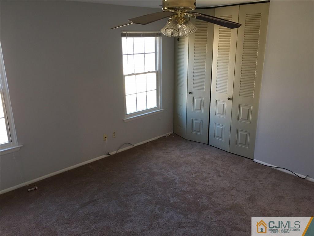 22 Woodbury Road Edison, NJ 08820 - Photo 21 of 25 an empty room with windows and chandelier
