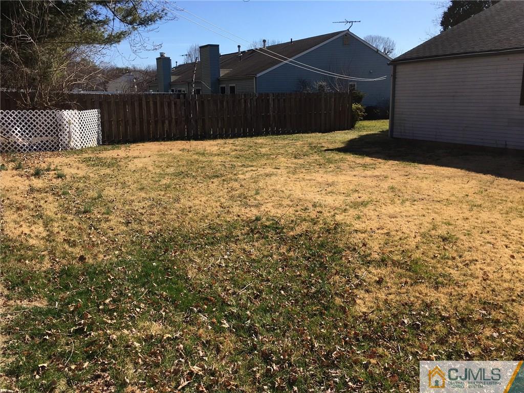 22 Woodbury Road Edison, NJ 08820 - Photo 5 of 25 a street view with wooden fence