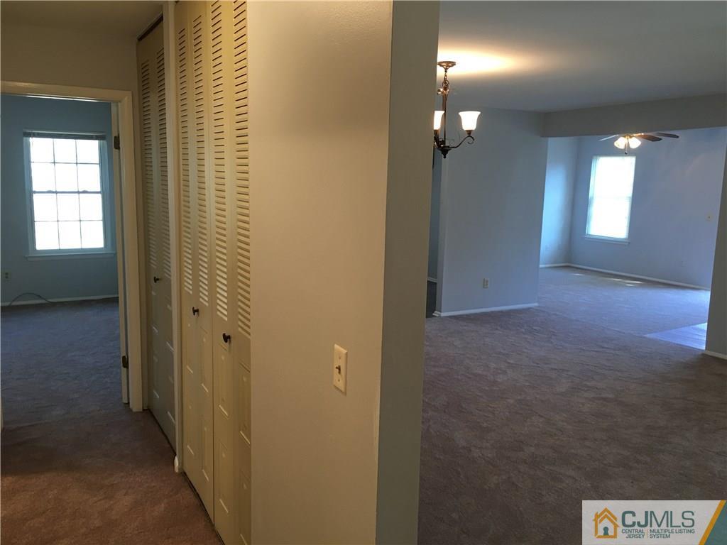 22 Woodbury Road Edison, NJ 08820 - Photo 8 of 25 a view of a hallway with wooden floor and a bathroom