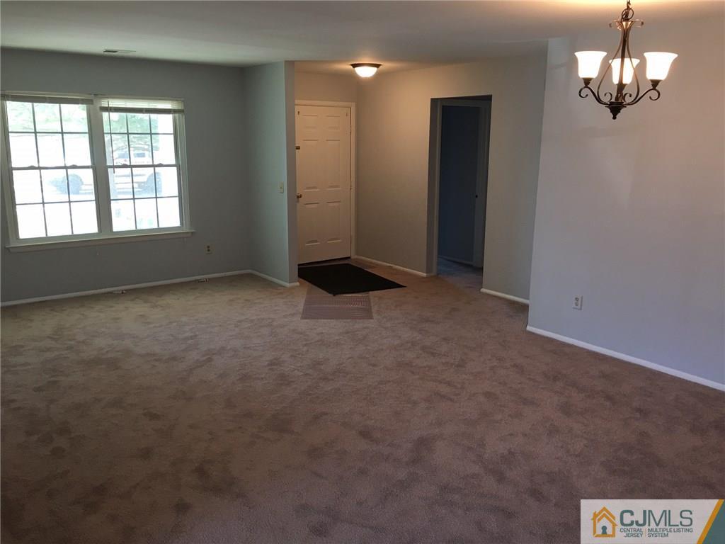 22 Woodbury Road Edison, NJ 08820 - Photo 10 of 25 en empty room with windows and ceiling fan