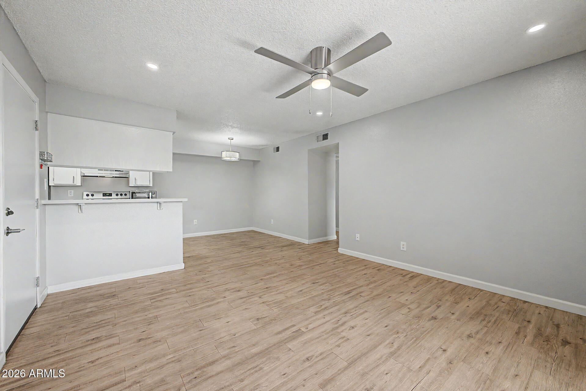 2625 East Indian School Road, Unit 227 Phoenix, AZ 85016 - Photo 9 of 31 a view of a kitchen with a dishwasher and wooden floor