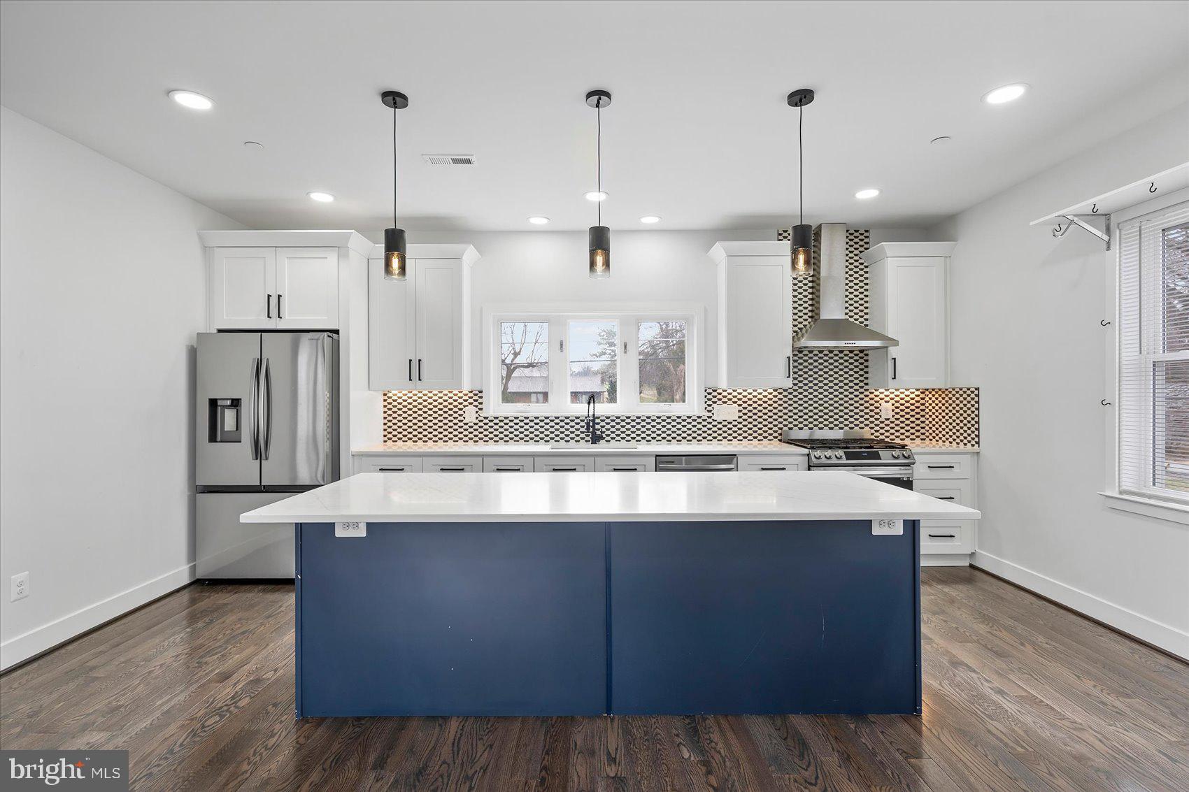 11030 Bird River Grove Road White Marsh, MD 21162 - Photo 17 of 53 a large kitchen with stainless steel appliances kitchen island a large island in the center