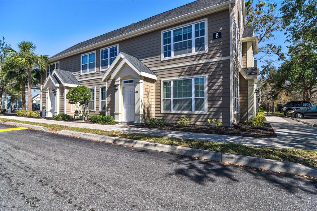 5631 Rosehill Road, Unit 203 Sarasota, FL 34233 - Photo 1 of 1 a front view of a house with a yard