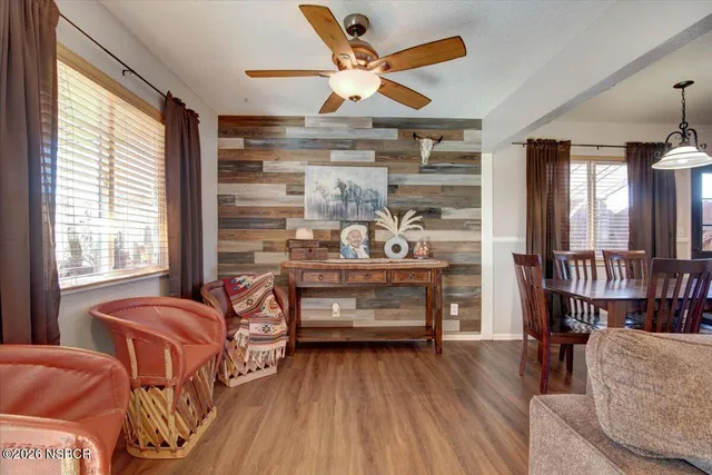 a bedroom with furniture and a large window