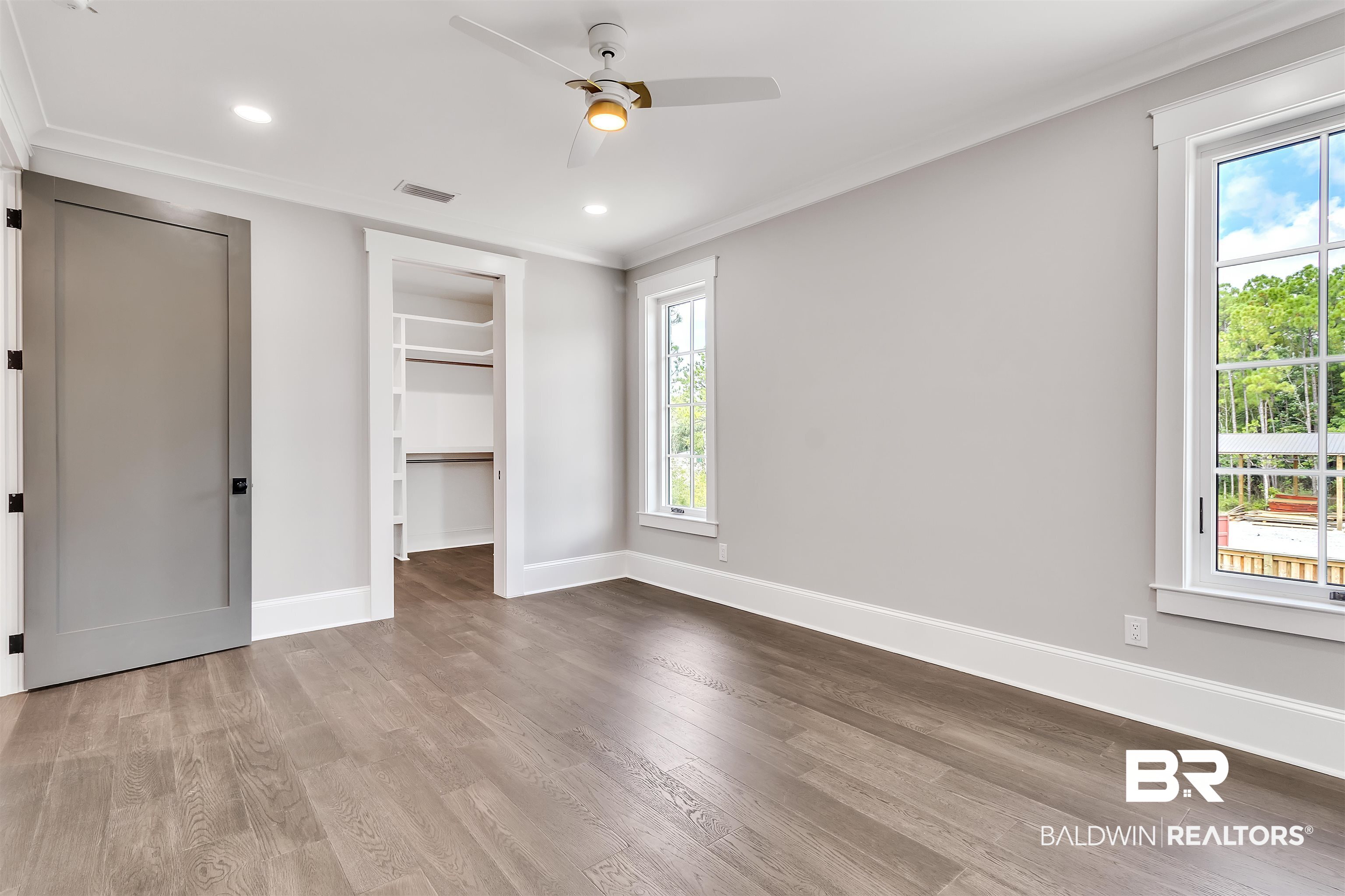 829 Inlet Circle Gulf Shores, AL 36542 - Photo 18 of 31 Unfurnished bedroom with ceiling fan, hardwood / wood-style flooring, and ornamental molding