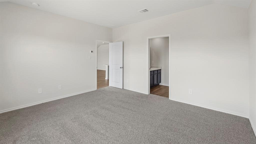 1969 Freeman Street Tyler, TX 75704 - Photo 14 of 30 Spacious room with light gray carpeting, neutral wall paint, and white trim
