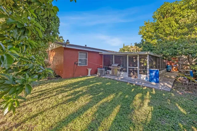 a view of a house with backyard sitting area and garden
