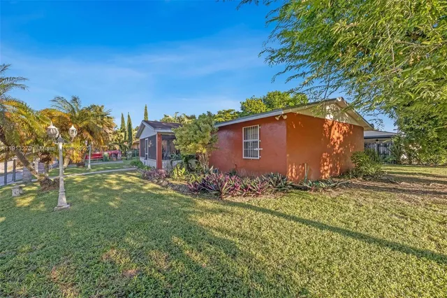 a view of a backyard with large trees