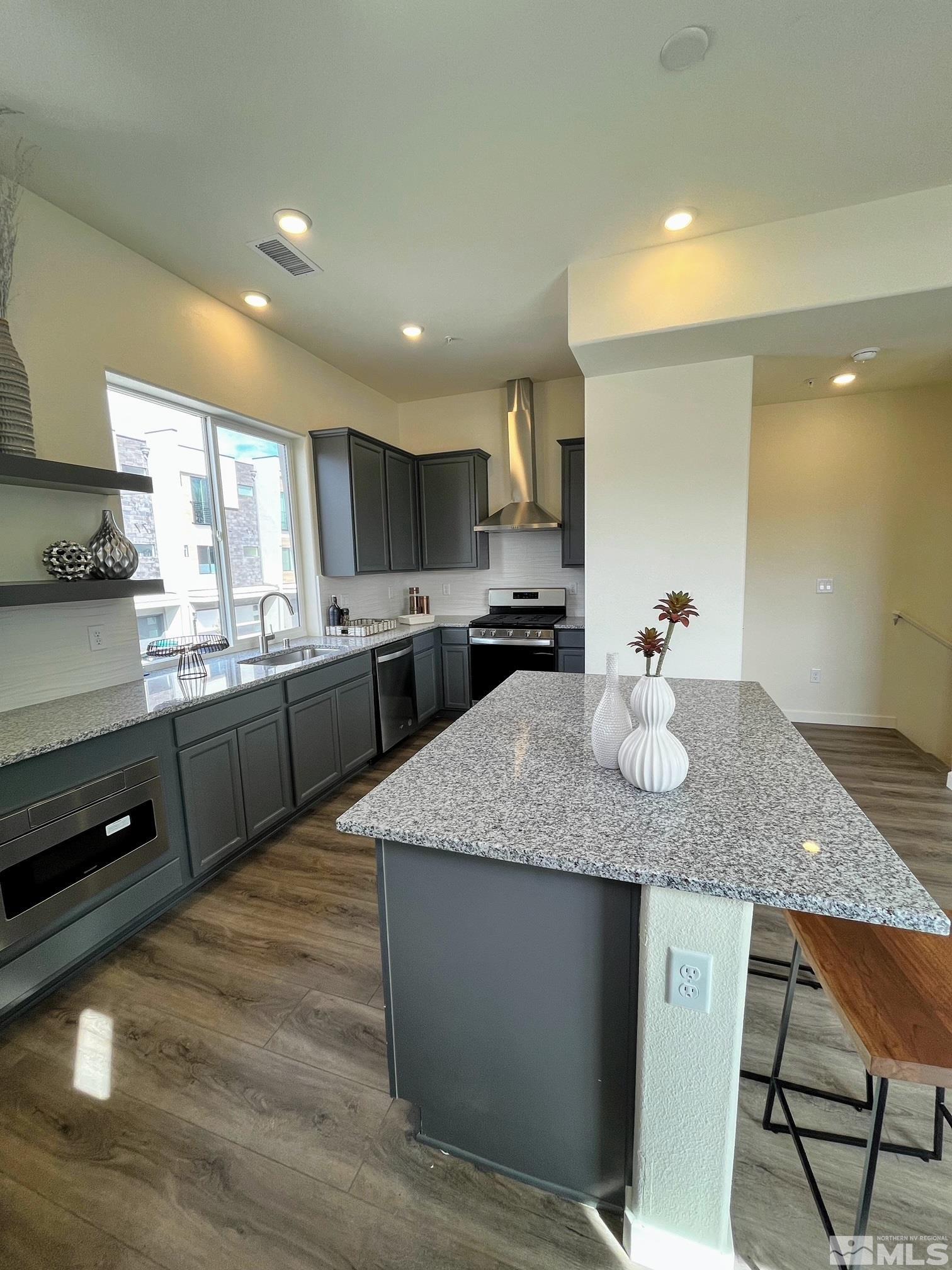 2592 Flowing Stream Street, Unit LOT #16 Reno, NV 89503 - Photo 3 of 15 a kitchen with stainless steel appliances granite countertop a sink counter space and cabinets