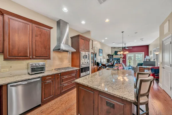 a kitchen with stainless steel appliances granite countertop a stove and a microwave