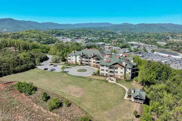 an aerial view of a houses with a yard