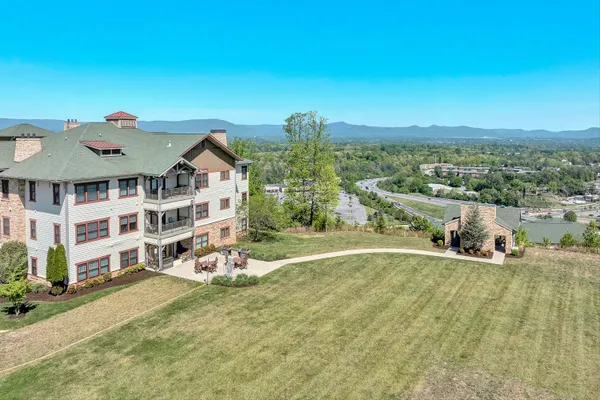 an aerial view of a house with a yard