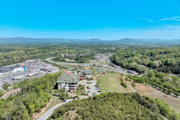 an aerial view of residential houses with outdoor space and trees