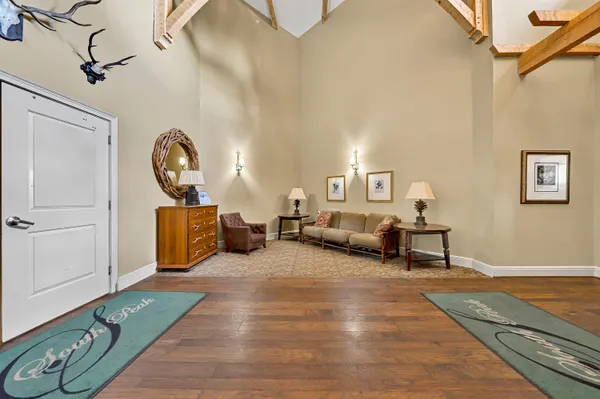 a view of a hallway to a room with a bedroom