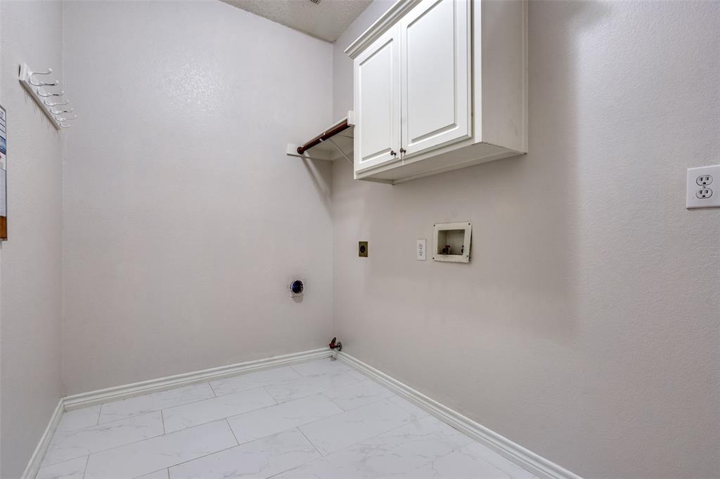 3421 Neiman Road Plano, TX 75025 - Photo 23 of 40 Laundry room with light marble finish floors, hookup for a gas dryer, cabinet space, hookup for an electric dryer, and washer hookup