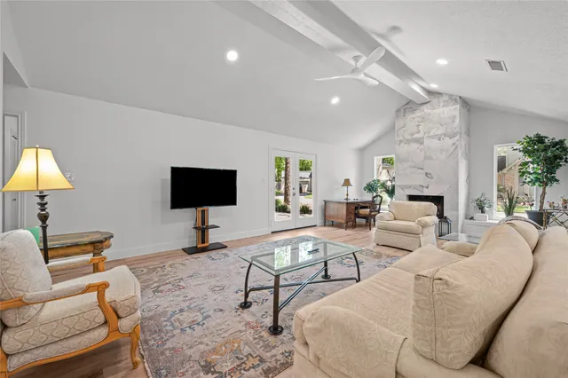 a living room with furniture a lamp and a flat screen tv