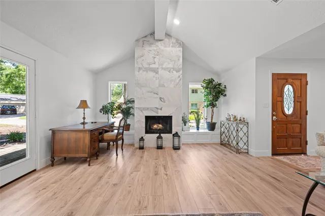 a living room with furniture and a fireplace