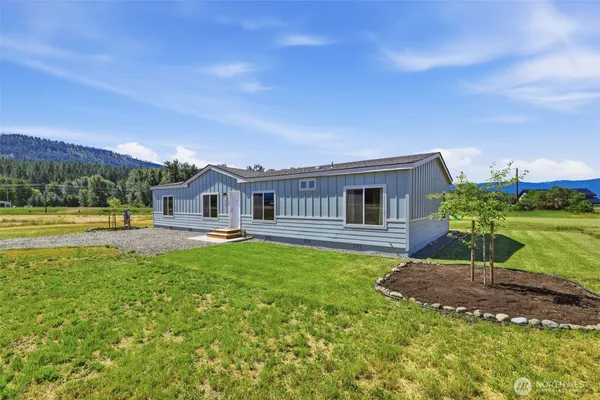 a front view of a house with yard swimming pool and outdoor seating