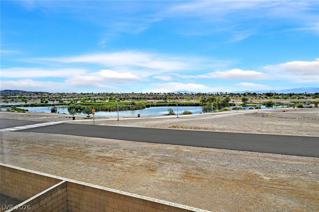 155 Fulgora Street Henderson, NV 89074 - Photo 23 of 30 An inviting community lake, bordered by natural landscaping and distant mountains, offers serene views.