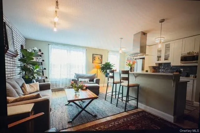 a living room with lots of furniture and kitchen view