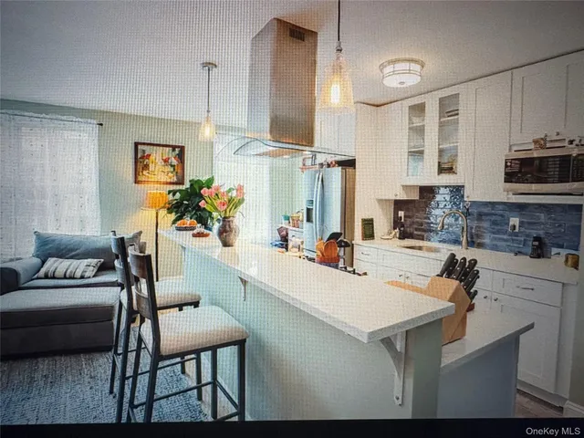 a kitchen with a sink appliances and cabinets