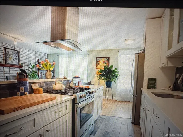 a kitchen with stainless steel appliances a sink stove and refrigerator