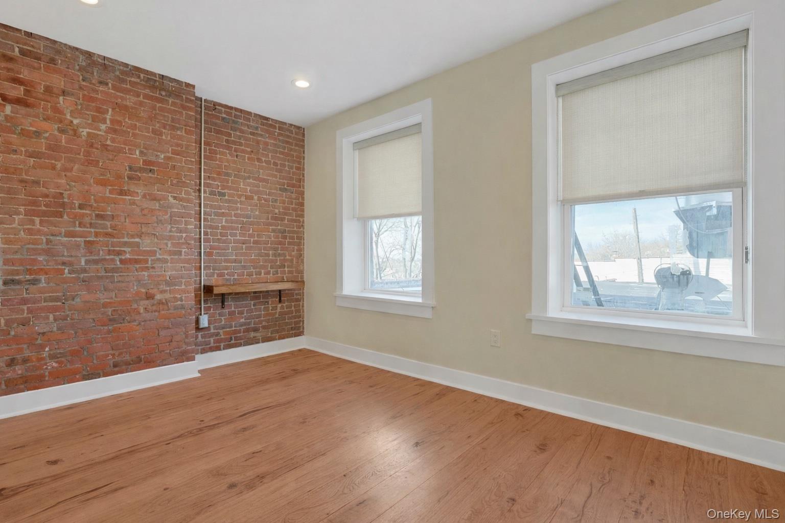 19 Main Street, Unit 2 Tarrytown, NY 10591 - Photo 13 of 24 a view of an empty room with wooden floor and a window