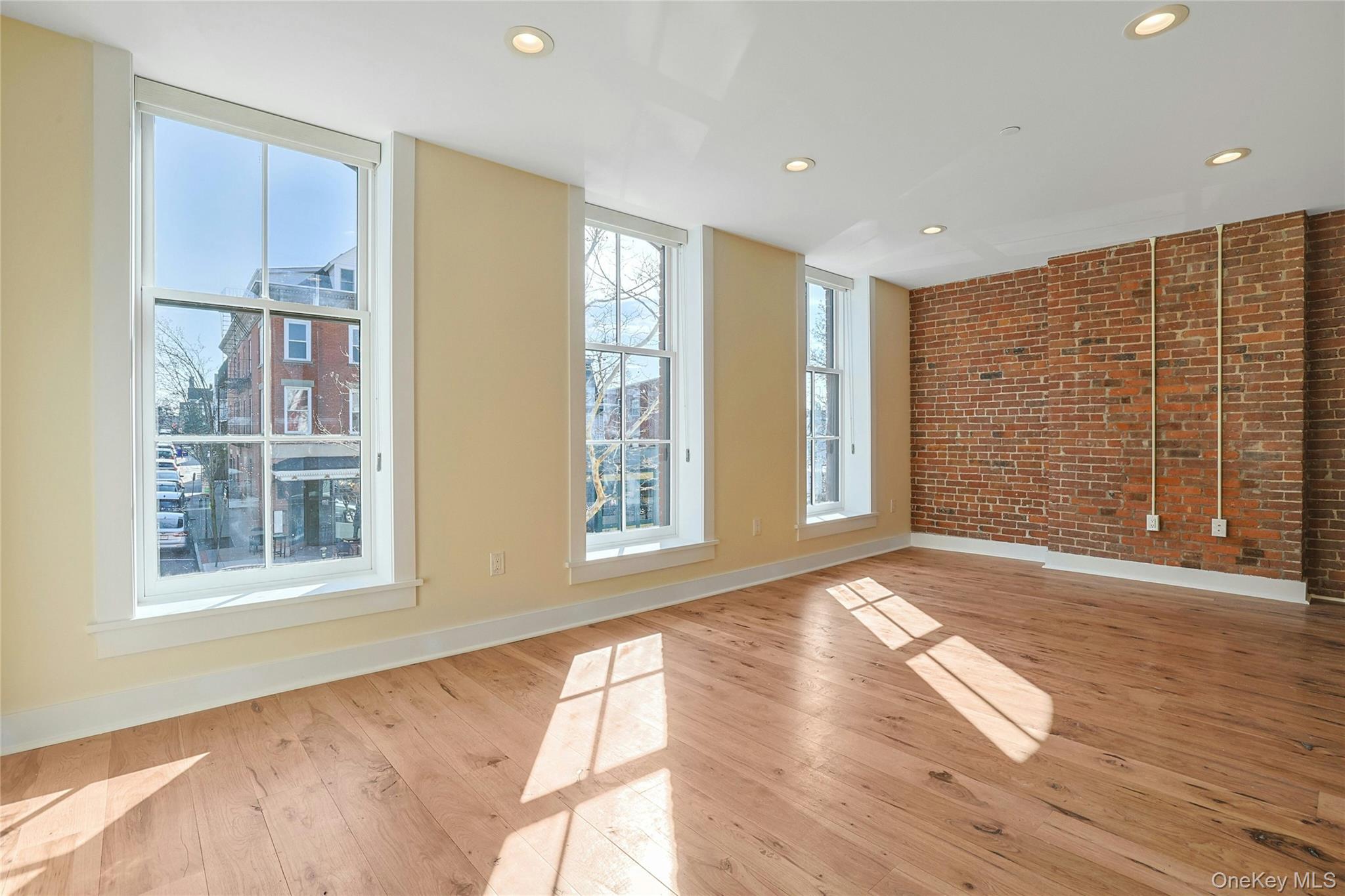 19 Main Street, Unit 2 Tarrytown, NY 10591 - Photo 5 of 24 a view of an empty room with wooden floor and a window