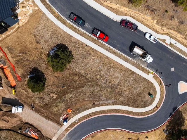 a view of a yard with wooden fence