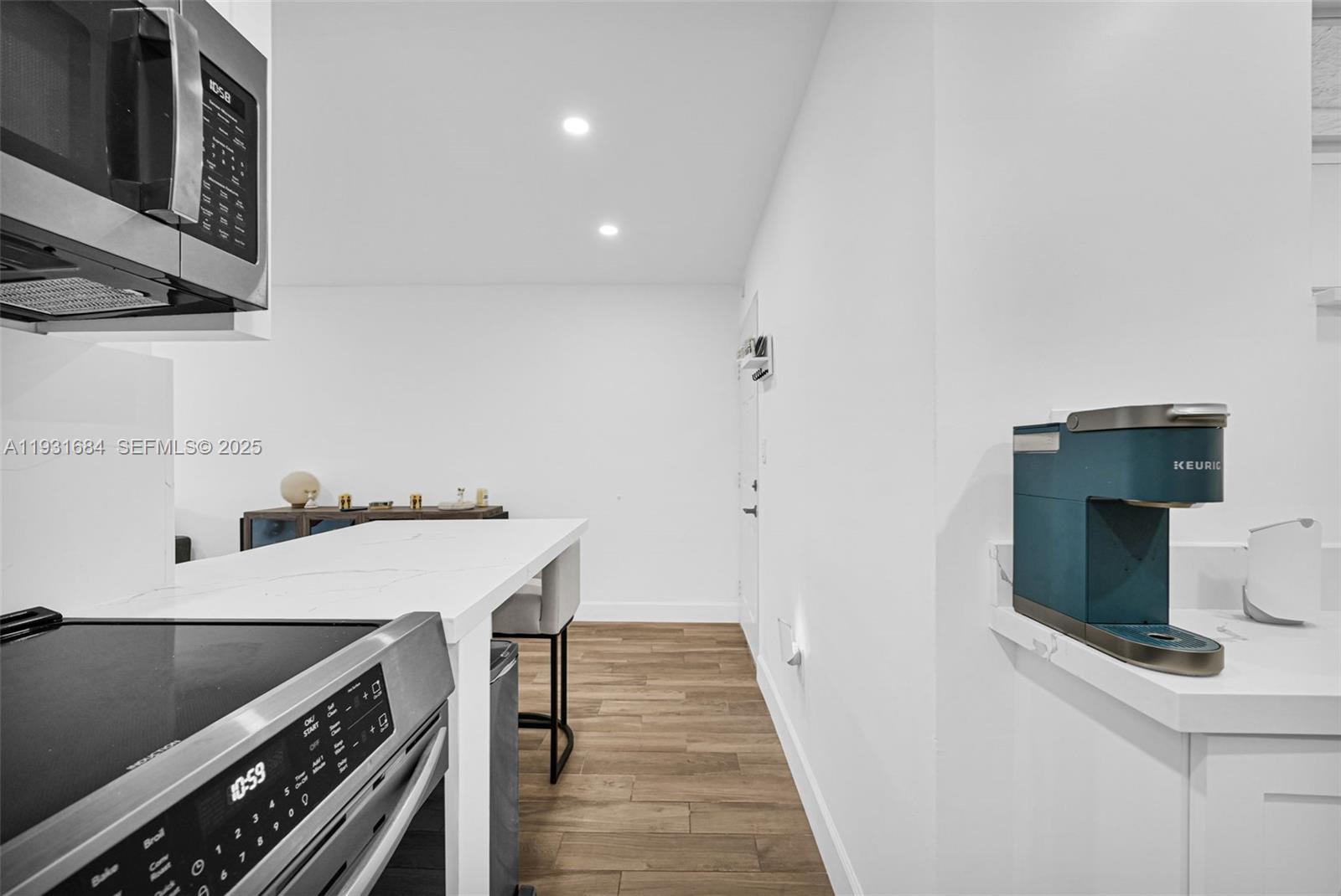 8609 Southwest 68th Court, Unit 24 Pinecrest, FL 33156 - Photo 12 of 40 a kitchen with a stove and a microwave