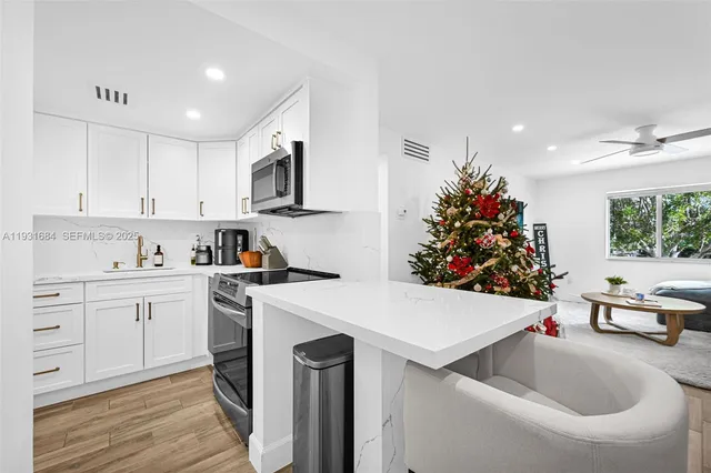a kitchen with a sink cabinets and wooden floor