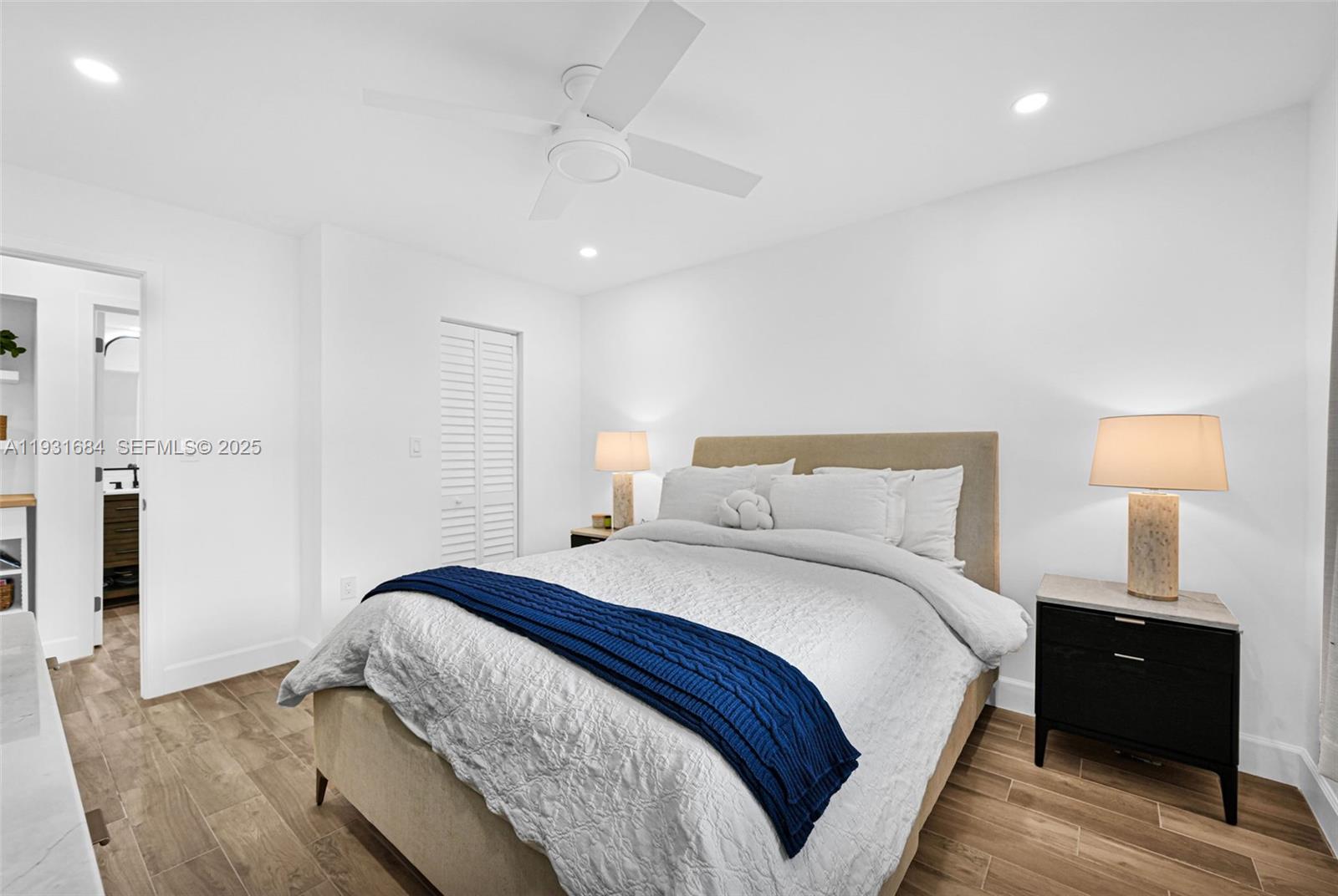 8609 Southwest 68th Court, Unit 24 Pinecrest, FL 33156 - Photo 24 of 40 a bedroom with a bed and a lamp