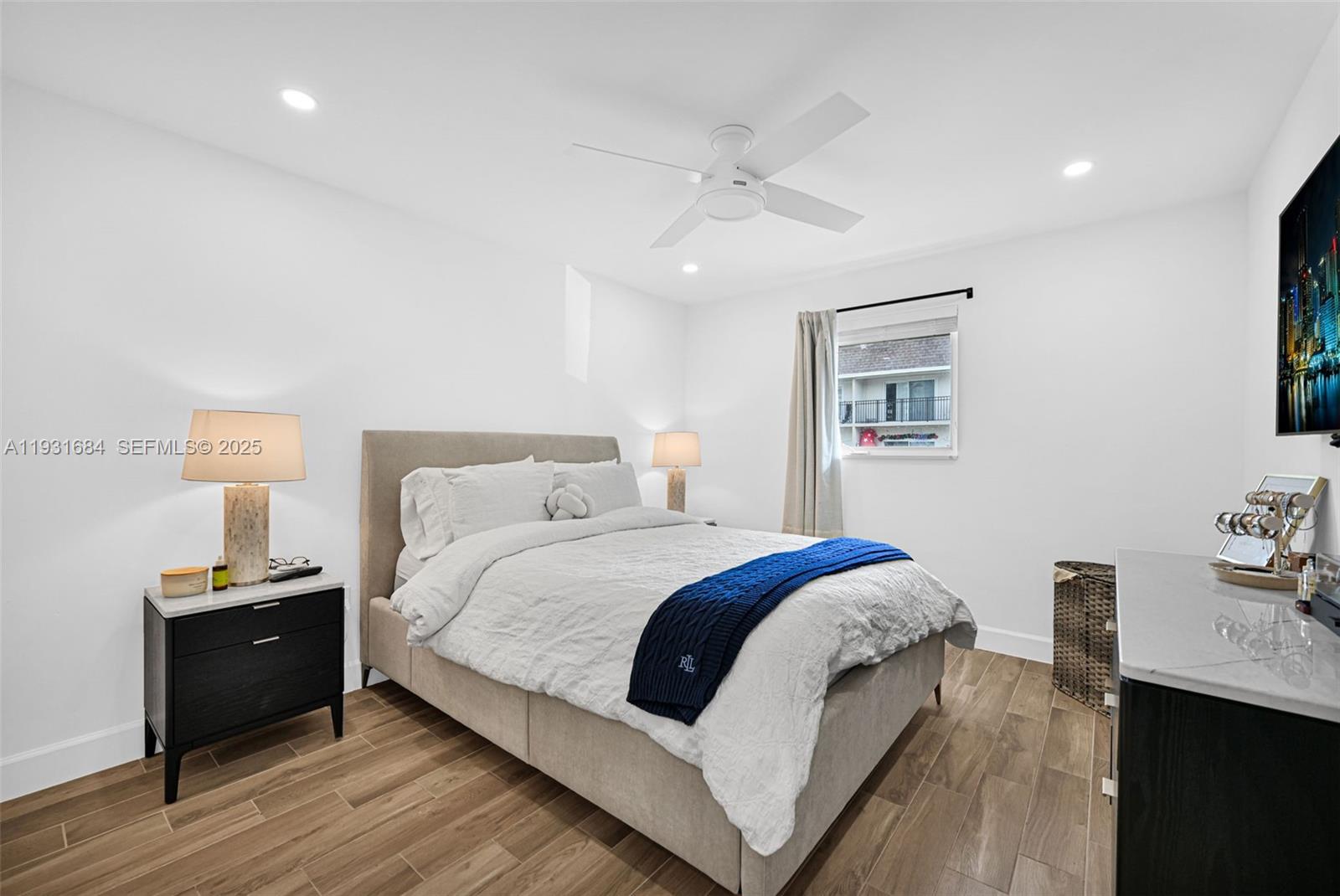 8609 Southwest 68th Court, Unit 24 Pinecrest, FL 33156 - Photo 26 of 40 a bed room with a bed and a night stand