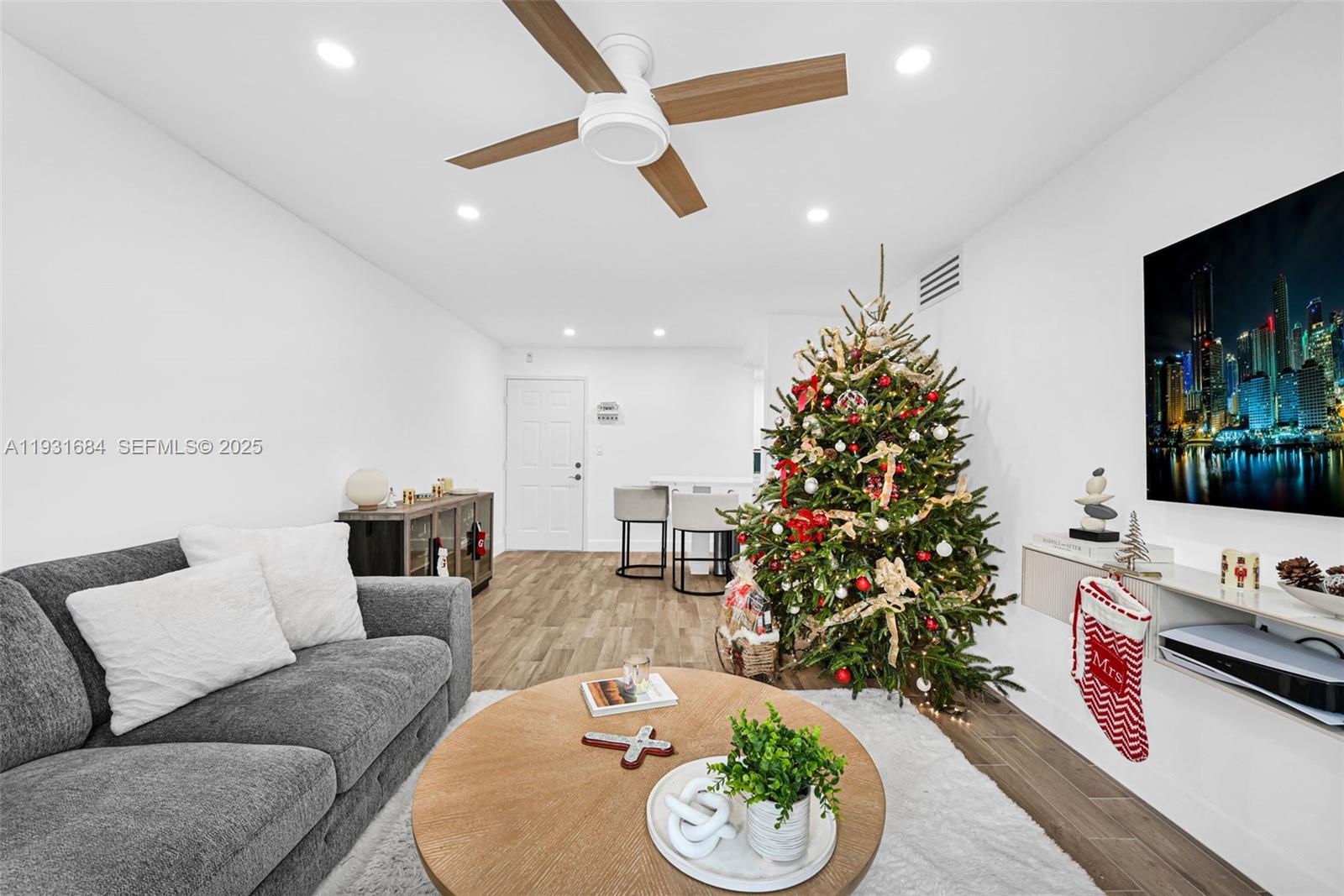 8609 Southwest 68th Court, Unit 24 Pinecrest, FL 33156 - Photo 3 of 40 a living room with furniture potted plant and a flat screen tv