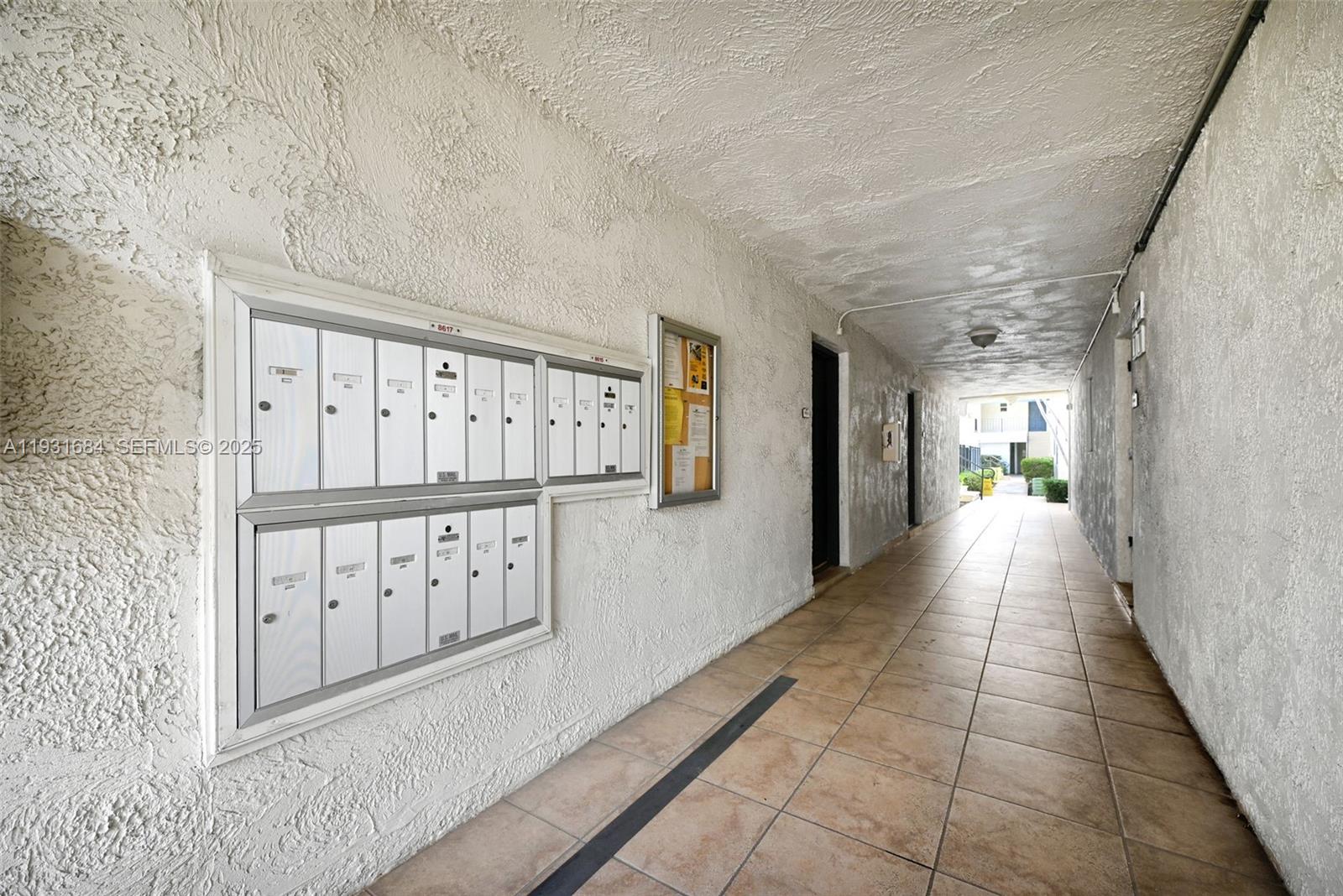 8609 Southwest 68th Court, Unit 24 Pinecrest, FL 33156 - Photo 34 of 40 a view of a hallway with wooden floor and staircase