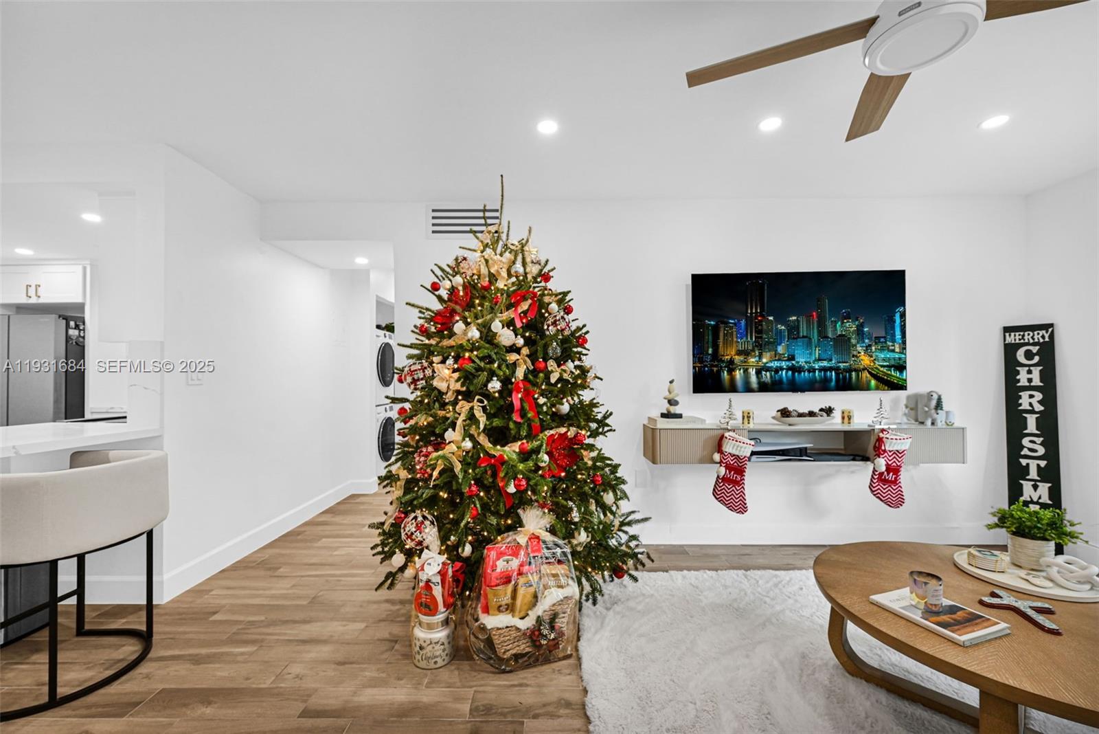 8609 Southwest 68th Court, Unit 24 Pinecrest, FL 33156 - Photo 7 of 40 a living room with furniture and a flat screen tv