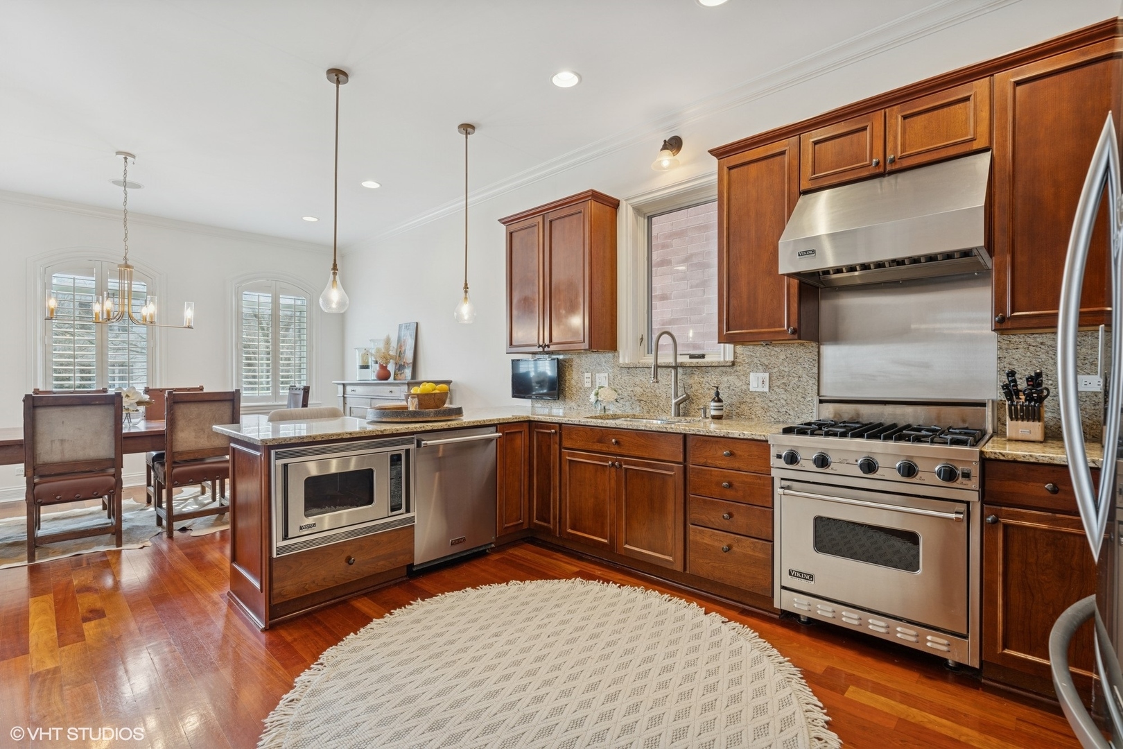 952 North Racine Avenue Chicago, IL 60642 - Photo 4 of 24 a kitchen with a stove a sink and chandelier