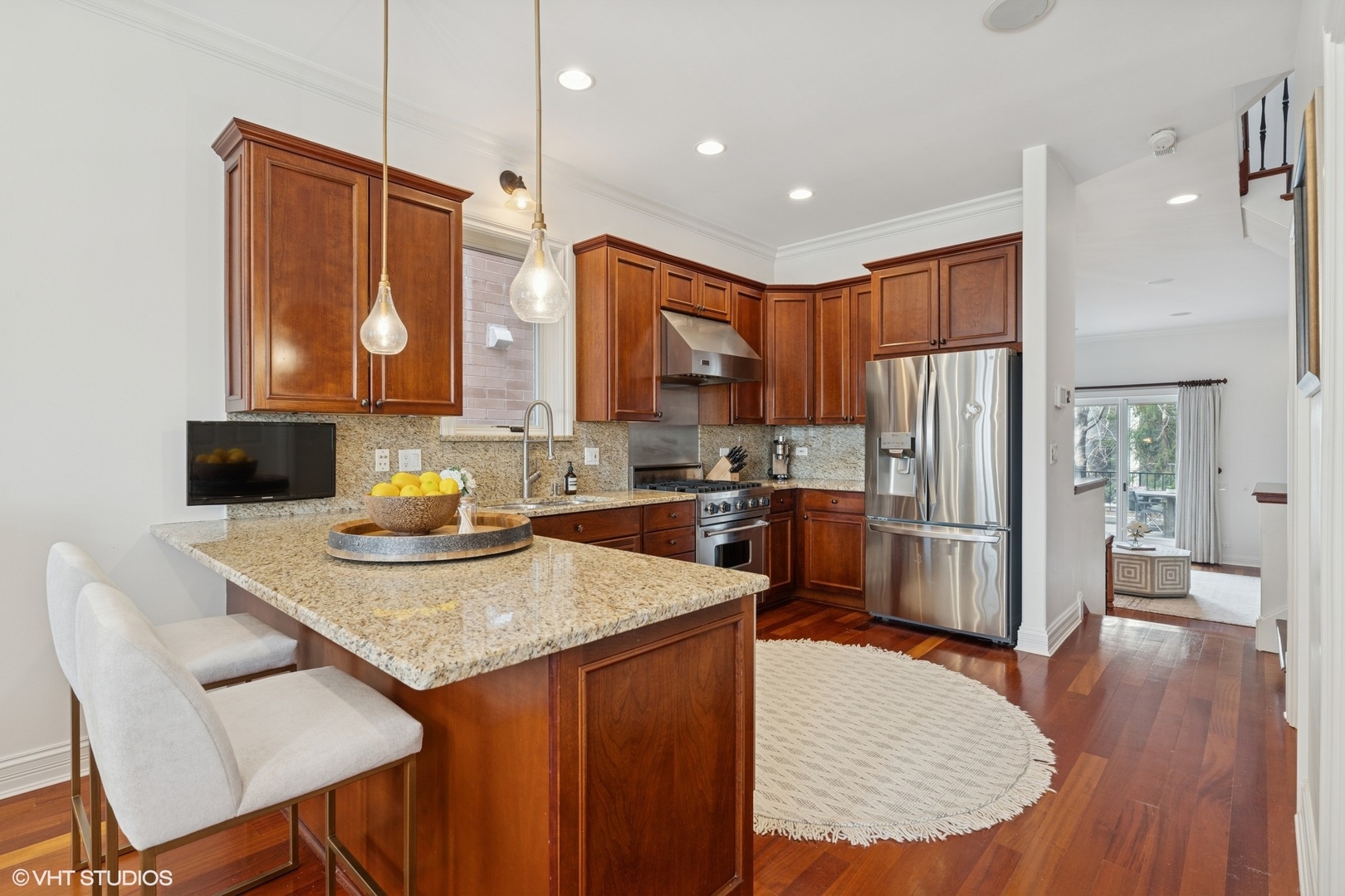 952 North Racine Avenue Chicago, IL 60642 - Photo 5 of 24 a kitchen with stainless steel appliances granite countertop a table chairs sink and refrigerator