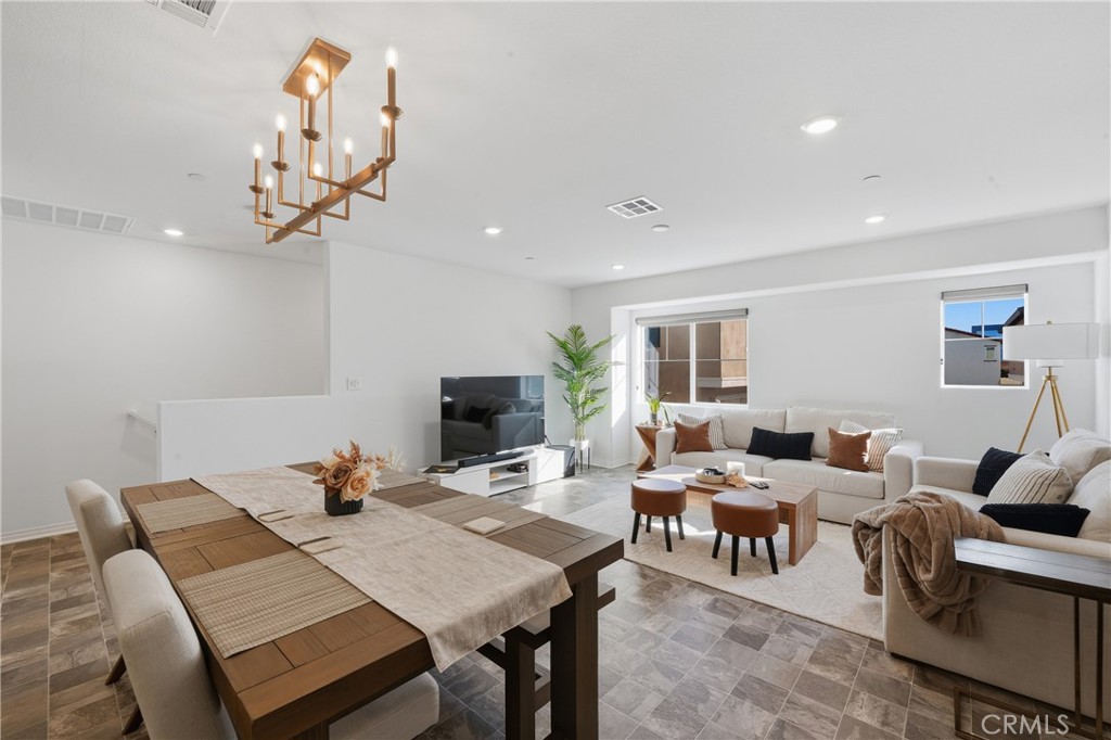 19210 Ash Grv Street Riverside, CA 92507 - Photo 12 of 38 a living room with furniture a chandelier and a flat screen tv