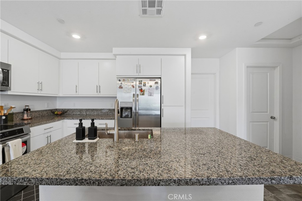 19210 Ash Grv Street Riverside, CA 92507 - Photo 18 of 38 a kitchen with sink cabinets and counter space