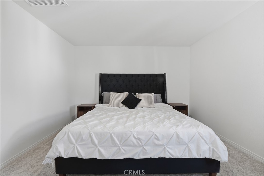 19210 Ash Grv Street Riverside, CA 92507 - Photo 20 of 38 a large bed sitting in a bedroom next to a wall