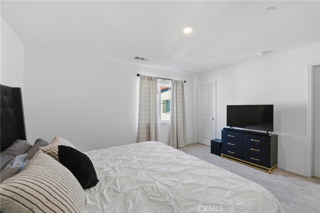 19210 Ash Grv Street Riverside, CA 92507 - Photo 21 of 38 a bedroom with a bed and a flat screen tv