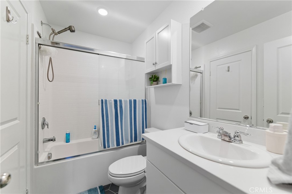 19210 Ash Grv Street Riverside, CA 92507 - Photo 22 of 38 a bathroom with a sink toilet and shower