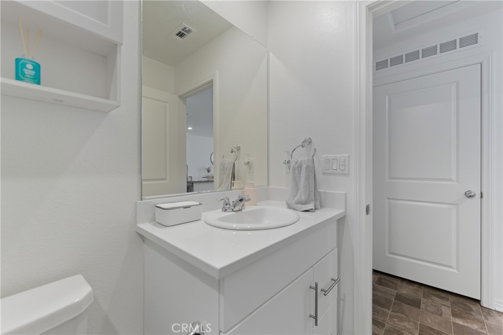 19210 Ash Grv Street Riverside, CA 92507 - Photo 24 of 38 a bathroom with a sink and a mirror