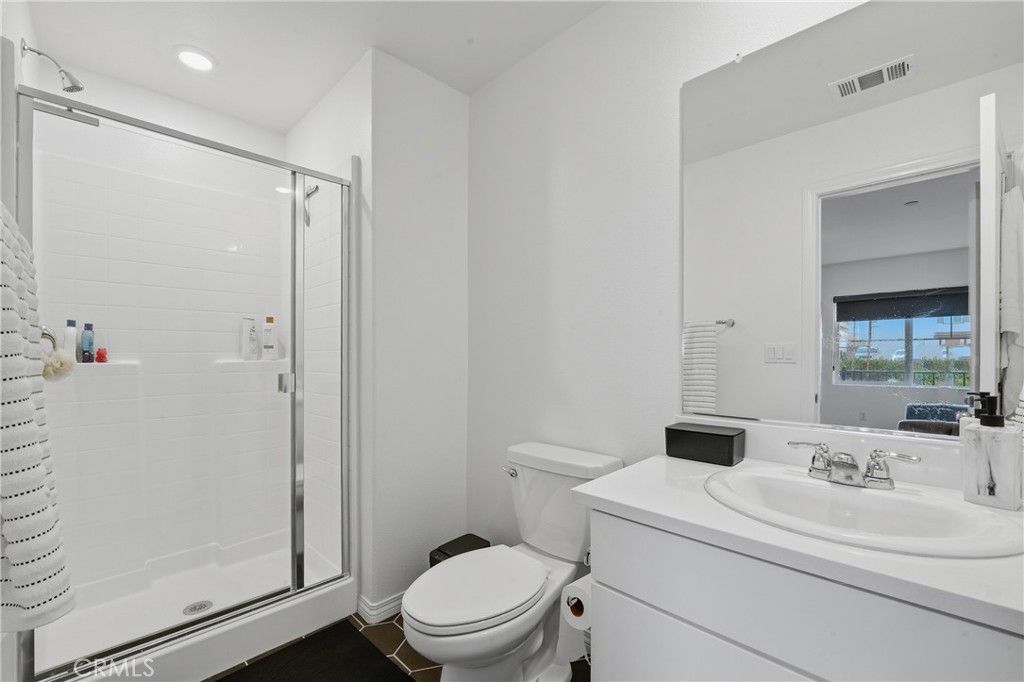 19210 Ash Grv Street Riverside, CA 92507 - Photo 28 of 38 a bathroom with a sink a toilet and shower
