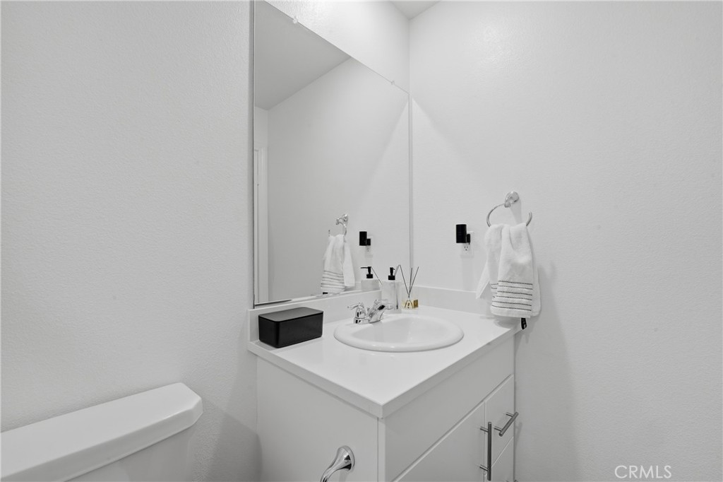 19210 Ash Grv Street Riverside, CA 92507 - Photo 30 of 38 a bathroom with a sink toilet and a mirror
